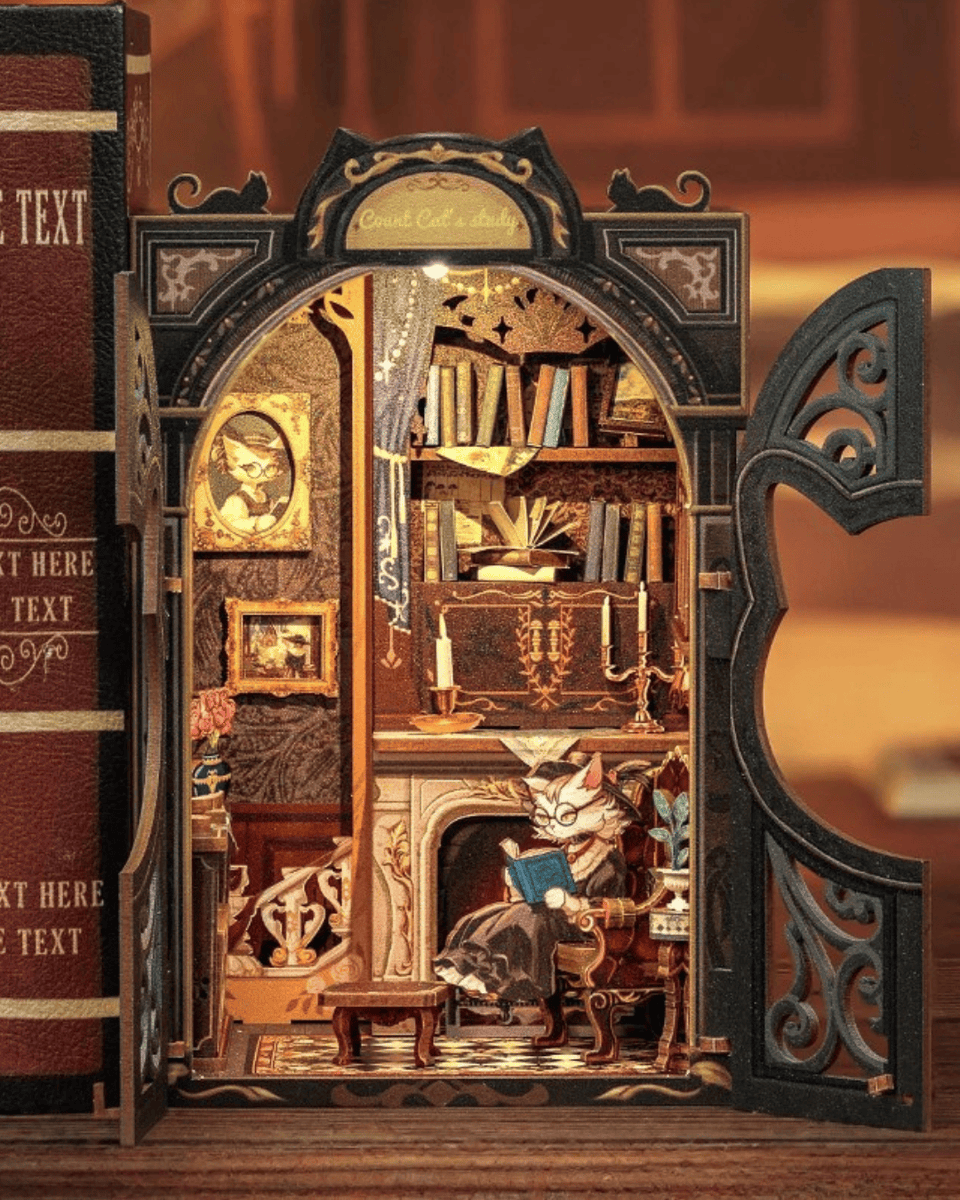 Miniature cat-themed book nook kit featuring a cozy study with books, fireplace, and LED lights