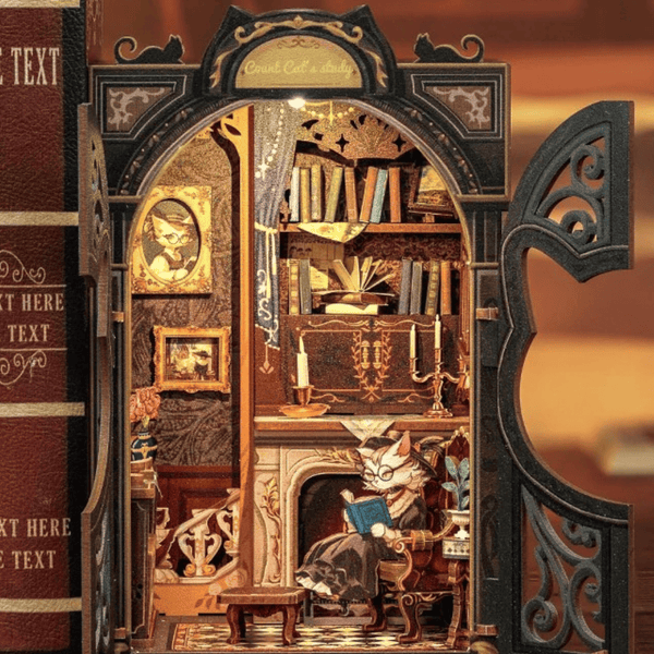 Miniature cat-themed book nook kit featuring a cozy study with books, fireplace, and LED lights